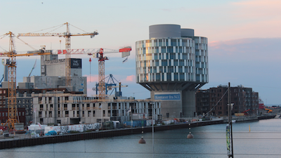 A construction site with lots of cranes around two buildings names 'The Silo'