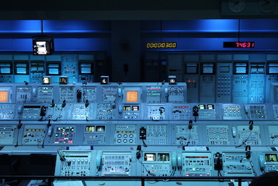 A satellite control center with 60s technologies, featuring lots of telephones, lights and buttons